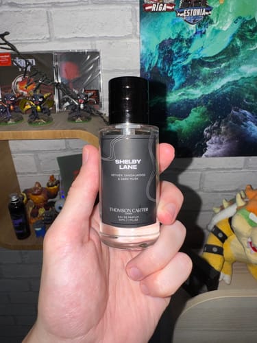 Customer holding a clear bottle of Shelby Lane Eau de Parfum in their hand.
