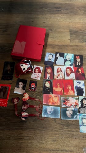 Customer's collection featuring the Jennie × Miniso Small Card Set and other merchandise laid out on a wooden surface.