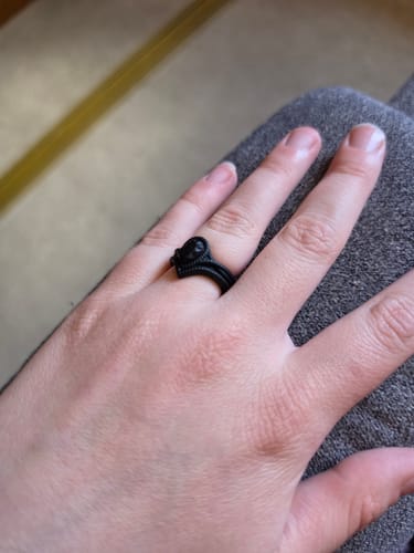 Customer's hand wearing the black Silicone Diamond Pear Collection ring.