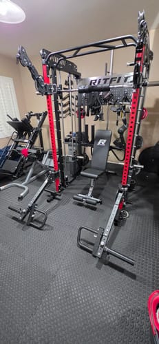 Customer's RitFit LAM1 Adjustable Lever Arm Attachments mounted on a power rack in a home gym.