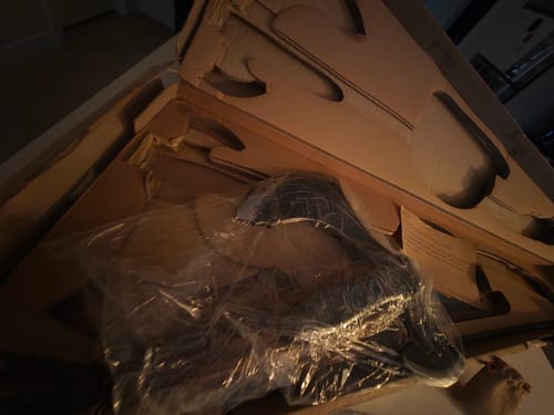 Reviewer's Ragnarok Kratos axe, partially wrapped in plastic, sitting inside its custom-cut box.