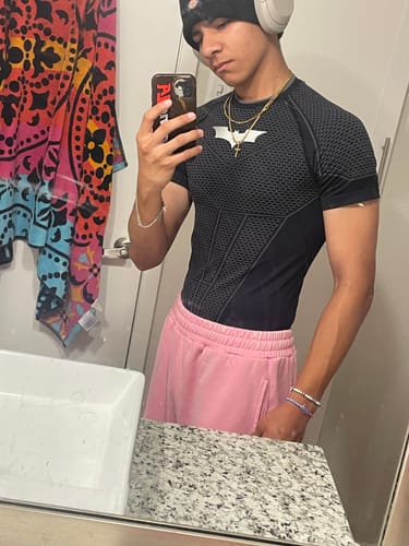 Reviewer wearing a black Batman Compression Tee with a structured armored-style pattern and a crisp Batman emblem.