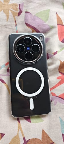 Customer's Anti Yellow Magsafe Clear Case for Vivo X200, showing circular magnetic ring, on floral fabric surface.