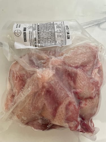 Customer's vacuum-sealed Halal Chicken Wings, showing raw meat in packaging.