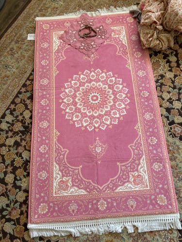 Customer's pink Rose Barakah Padded Prayer Mat with intricate floral pattern and tasbih on top.