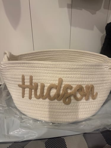 Customer's off-white Baby Knits Personalized Knitted Basket with the name Hudson stitched in tan yarn.