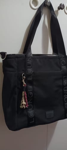 Customer's black Bolso Nylon Llavero Street hanging, showing the decorative keychain and brand label.