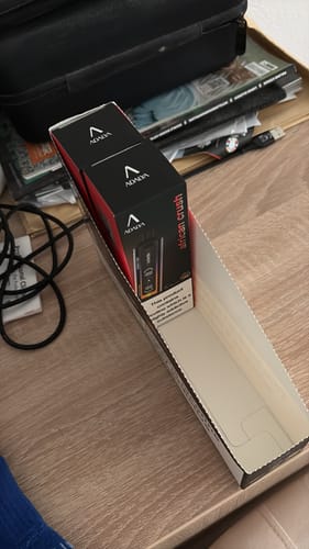 Customer's Adalya ADL16000 Puffs Disposable Vape boxes sitting in a cardboard display tray on a wooden table.