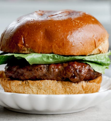 Customer's moist and juicy burger made with Grass-fed Grass-finished Ground Beef, topped with fresh lettuce.