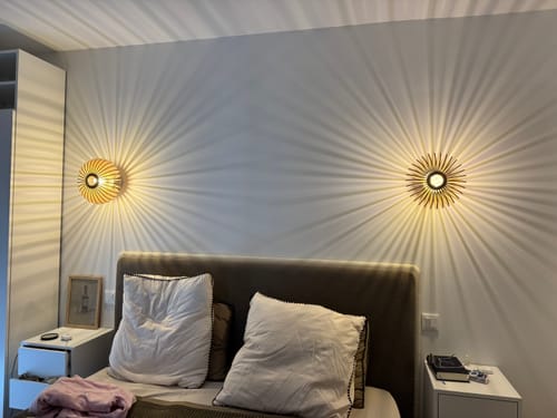 Customer's Mini Néo appliques en bois installées en duo au-dessus d'une tête de lit, diffusant une lumière rayonnante