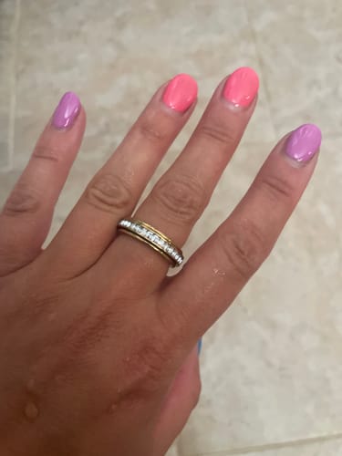 Customer's Calmy relaxation ring with a crystal band worn on a finger.