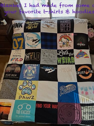 Customer's Project Repat T-Shirt Quilt featuring a patchwork of colorful fabric squares displayed on a bed.