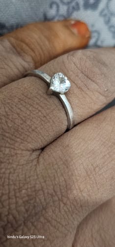 Customer's silver Passionate Love ring with a heart-shaped zircon worn on their finger.