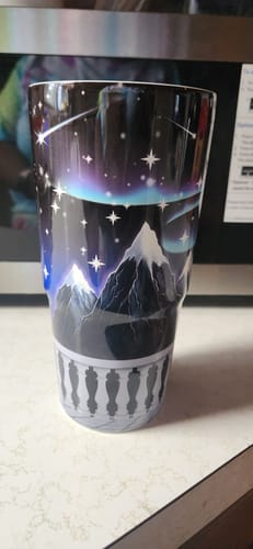 Customer's To-Go Buddy tumbler featuring a dark Nightfall scene with snow-capped mountains and stars.