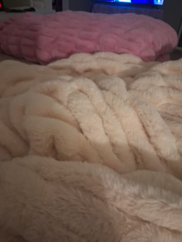 Reviewer's soft blankets, one pink and one cream, draped on a surface.