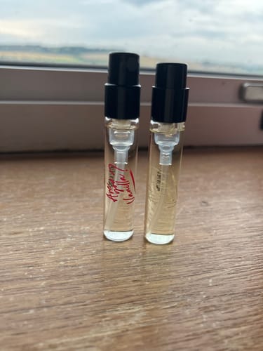 Customer's Are You Vanilla Day and Night perfume samples in clear glass vials, standing on a wooden surface.