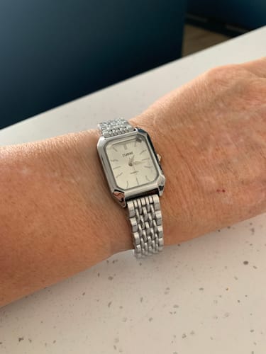 Customer's silver Claire De Mains watch with a classic bracelet worn on the wrist.
