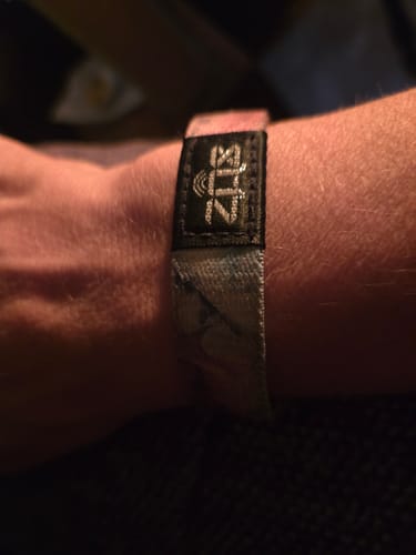 Customer's Just For Today bracelet worn on a wrist, featuring a black ZOX tag and patterned fabric.