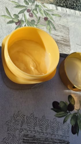 Customer's Shiseido Tsubaki Premium Ex Intensive Repair Mask in an open yellow jar showing the creamy hair treatment.
