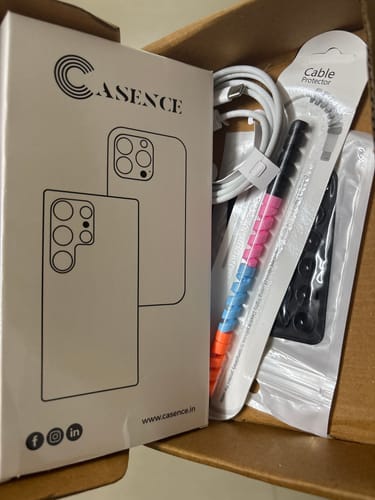 Customer's Anti Yellow Magsafe Clear Case packaging box next to a white cable and multi-colored cable protector inside a box