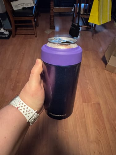 Customer's hand holding the Nebula Glitter Universal Buddy can cooler with a purple rim.