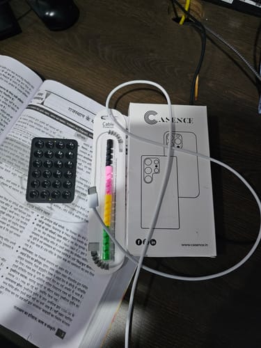 Customer's packaging for UltraShield Tempered Glass shown next to a charging cable and protective case box