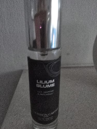 Customer's Lilium Blume fragrance bottle standing on a table, close-up view of the slim spray bottle.