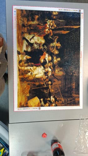 Customer's De Nachtwacht diamond painting, a detailed reproduction of the famous painting on a work table.