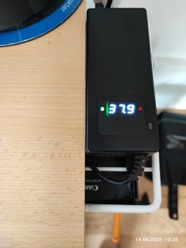 Reviewer's Engwe L20 SE battery shown plugged in, displaying a 37.9 reading on the digital screen.