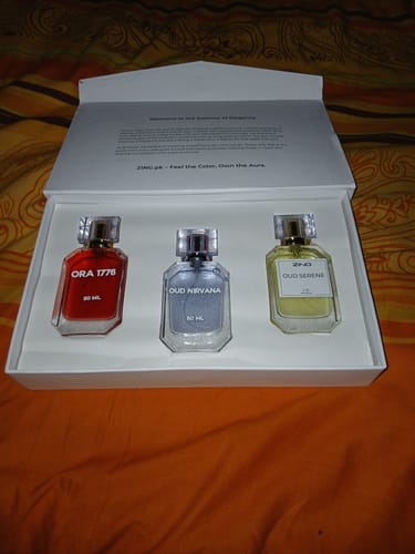 Customer's OUD Supreme Bundle set featuring three perfume bottles, one red, one blue, and one yellow, inside an open box.