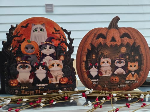 Customer's two personalized wooden Halloween cat plaques displayed upright on a wooden base.