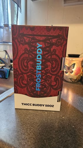 Customer's Thicc Buddy 50oz packaging, featuring a red and black lace print box standing on a kitchen counter.