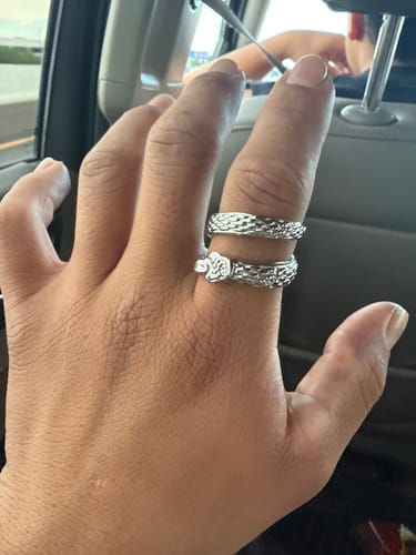 Customer's shiny silver Upgraded Slime Ring wrapped around a finger while sitting in a car.