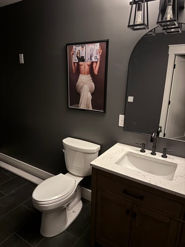 Customer's Made To Look V2 art print hanging on a dark gray bathroom wall.