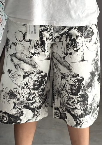 Customer's David Desen Jr Baggy Jean Şort, white with black lion print designs worn by a person.