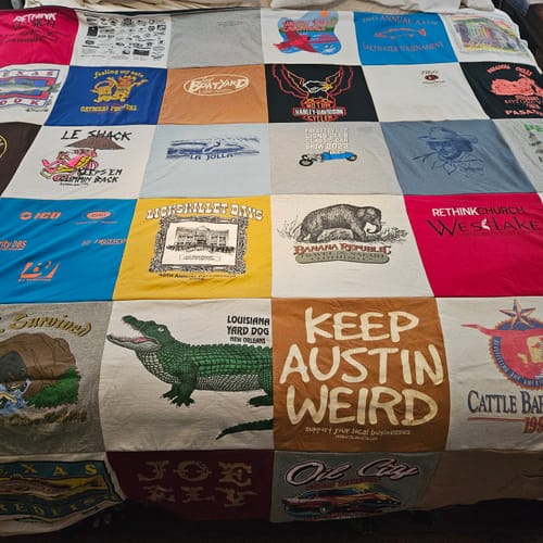 Customer's Project Repat T-Shirt Quilt featuring a patchwork of colorful vintage shirts with various logos.