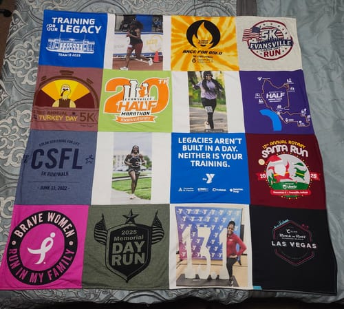 Customer's Project Repat T-Shirt Quilt featuring a grid of various race shirts and photos on a grey bedspread.