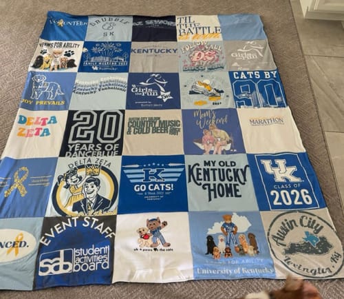 Customer's Project Repat T-Shirt Quilt featuring various blue and grey university-themed t-shirt squares.