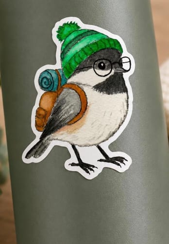 Customer's Custom Sample Sticker of a bird wearing glasses, a green hat, and a backpack, on a grey bottle.