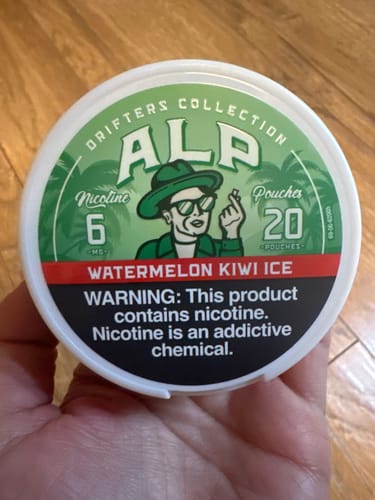 Customer's hand holding a round container of Drifters Watermelon Kiwi Ice nicotine pouches