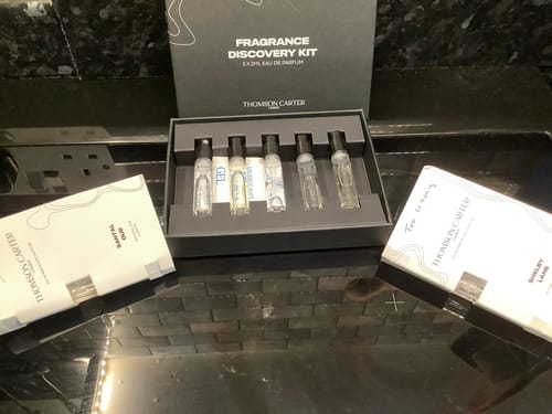 Customer's Rouge Avenue discovery kit box with sample perfume vials and branded scent cards.