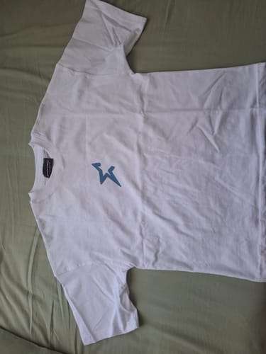 Customer's beyaz Idol House Grand Final Merch t-shirt, laying flat to show the blue star logo on the chest.