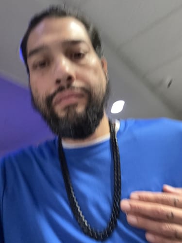 Customer's Knights Templar Sacred Oath Cuban Link Necklace worn on a blue shirt