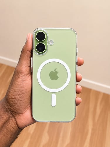Customer's hand holding the Anti Yellow Magsafe Clear Case on a light green phone with a visible magnetic ring.