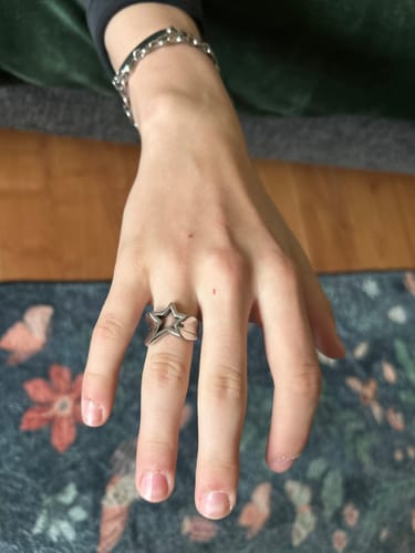 Reviewer's hand wearing a silver Starpoint Ring with a star-shaped design.