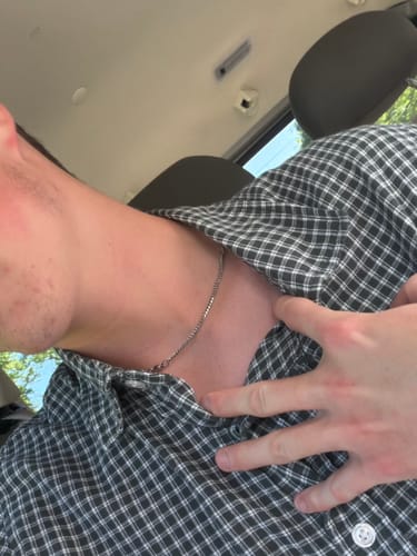 Customer's Minimalist Cuban Chain, a polished silver chain, worn around the neck of a person in a plaid shirt.