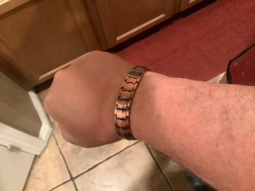 Reviewer's wrist wearing the Vitalis Copper Magnetic Bracelet, featuring a metallic finish and segmented design.