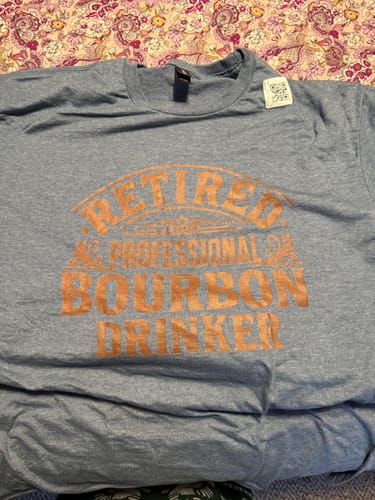 Customer's heather blue Retired Professional Bourbon Drinker T-Shirt with light orange lettering.