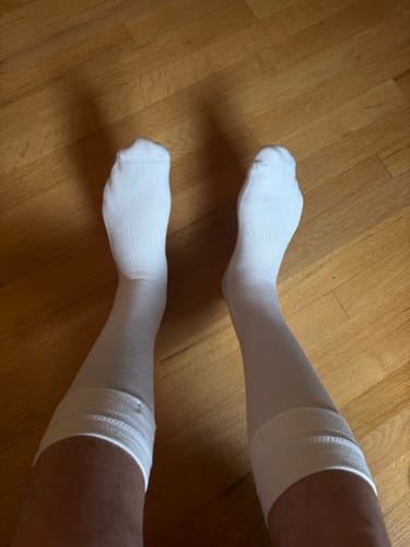 Customer's white Eucalyptus Lyocell Compression Socks worn on both legs, reaching just below the knee.