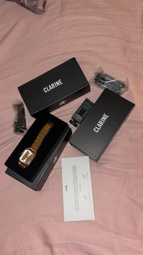Customer's gold Claire De Mains watch in open black branded box with accessories and instruction card.
